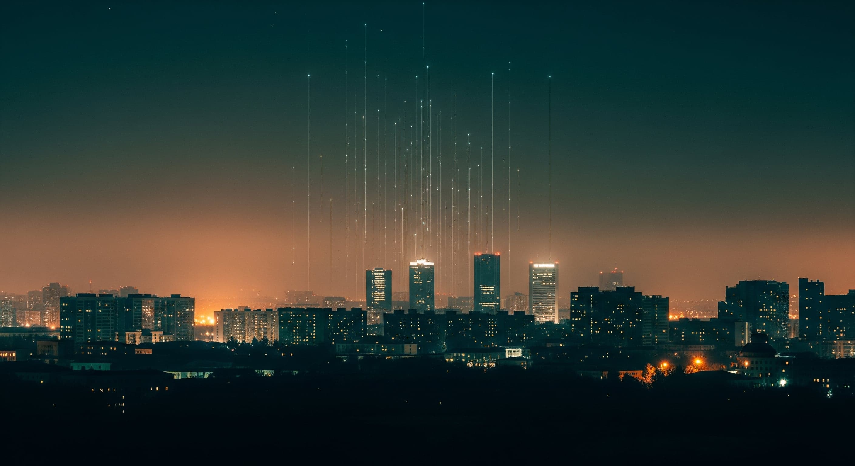 Night skyline of Ulaanbaatar with faint vertical light streams rising toward the stars.